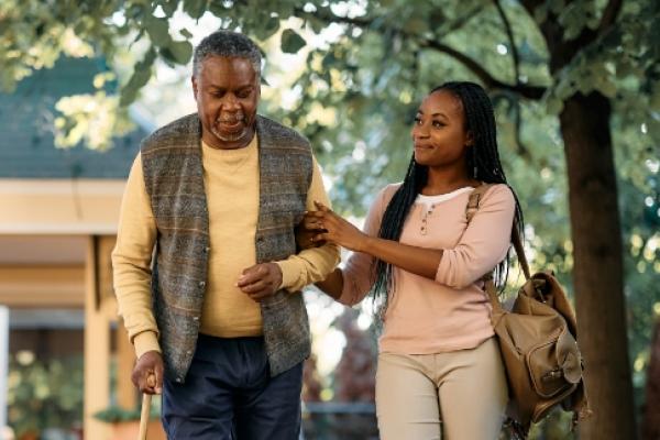 Older man walking with younger woman